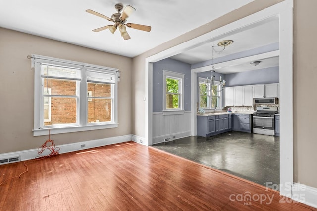 524 W Horah St, Salisbury, NC 28144 - kitchen featuring appliances with stainless steel finishes, gray cabinetry, a ceiling fan, decorative light fixtures, and light countertops