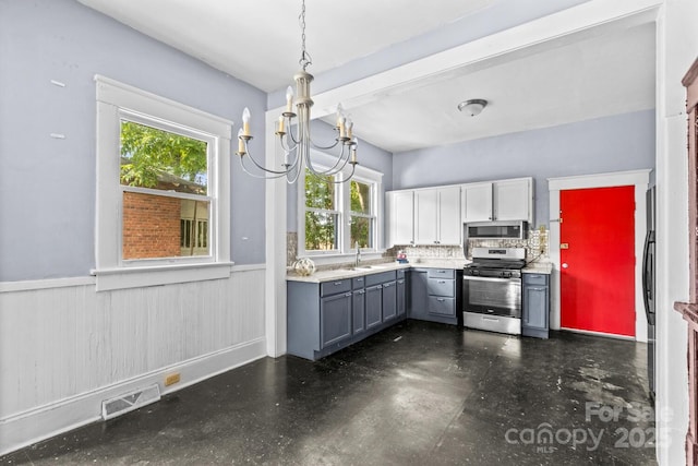 524 W Horah St, Salisbury, NC 28144 - kitchen featuring stainless steel appliances, gray cabinetry, wainscoting, plenty of natural light, and light countertops