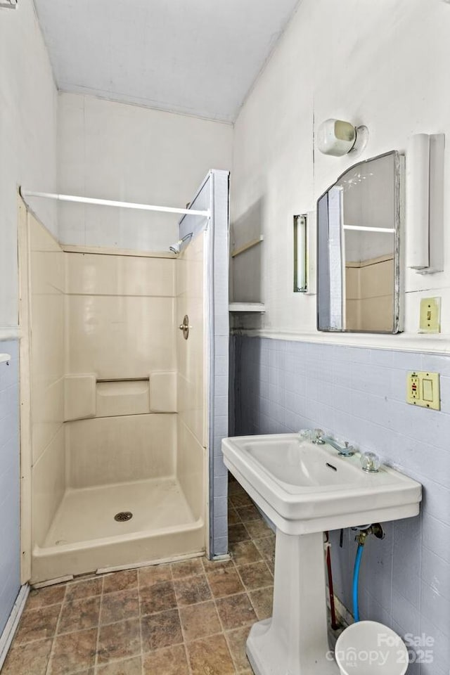 524 W Horah St, Salisbury, NC 28144 - full bathroom featuring a stall shower, tile walls, and stone finish flooring
