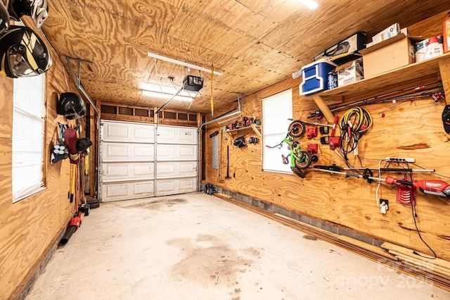 166 Duke St, Granite Falls, NC 28630 - garage with a garage door opener, wood walls, and electric panel