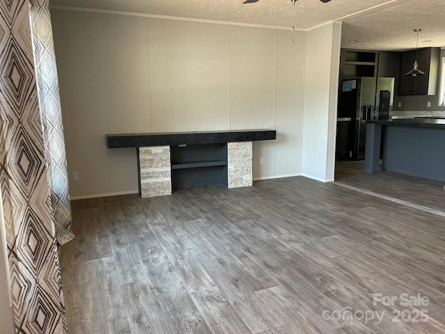 4172 Tallent Rd, Morganton, NC 28655 - unfurnished living room with a ceiling fan, crown molding, wood finished floors, and a textured ceiling