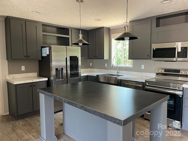4172 Tallent Rd, Morganton, NC 28655 - kitchen featuring appliances with stainless steel finishes, open shelves, a textured ceiling, light wood-type flooring, and a center island