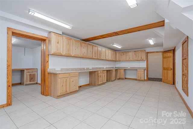 288 Hard To Find Dr, Brevard, NC 28712 - kitchen with built in study area, light brown cabinetry, light countertops, and light tile patterned floors