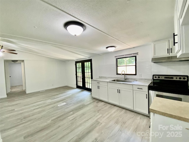 325 Scaley Bark Dr, Salisbury, NC 28147 - kitchen featuring french doors, stainless steel electric stove, light wood-style flooring, white cabinetry, and a textured ceiling