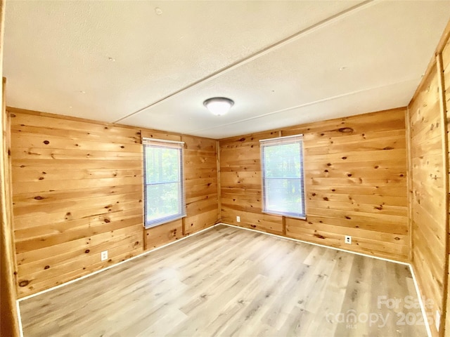 325 Scaley Bark Dr, Salisbury, NC 28147 - empty room featuring light wood-style flooring and wooden walls