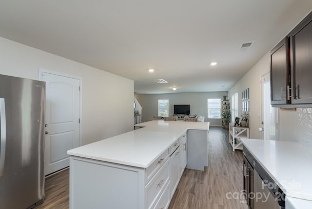 1736 Rhynes Trl, Rock Hill, SC 29732 - kitchen with freestanding refrigerator, light wood-style floors, a kitchen island, light countertops, and open floor plan