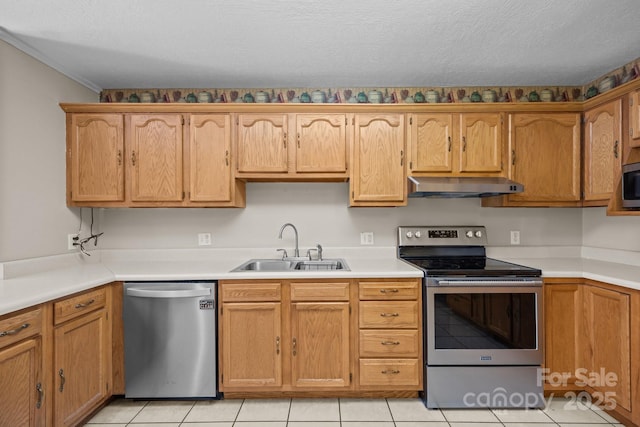 73 Waters Rd, Asheville, NC 28805 - kitchen with stainless steel appliances, under cabinet range hood, light tile patterned flooring, light countertops, and a textured ceiling