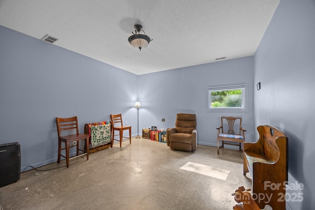 73 Waters Rd, Asheville, NC 28805 - sitting room with concrete flooring and a textured ceiling