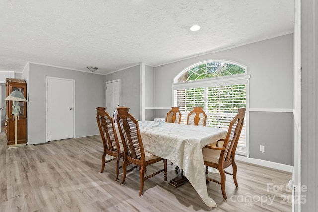 27 Sage Way, Clyde, NC 28721 - dining room featuring light wood-style floors, a textured ceiling, and crown molding
