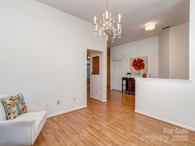 4801 Pennant Pl, Charlotte, NC 28212 - unfurnished room featuring a chandelier, wood finished floors, and a textured ceiling