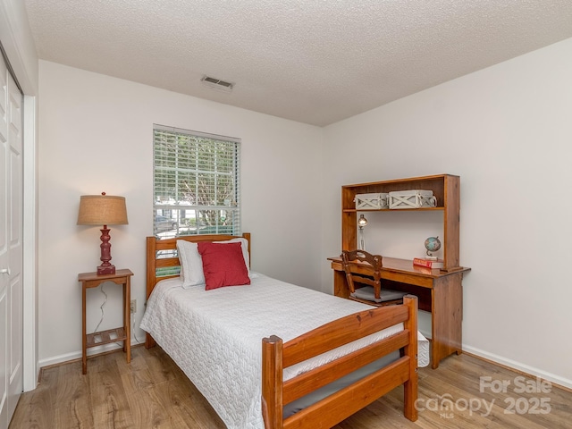 4801 Pennant Pl, Charlotte, NC 28212 - bedroom featuring wood finished floors and a textured ceiling