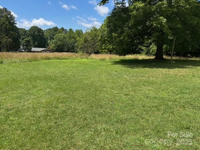 2417 Statesville Blvd, Salisbury, NC 28147 - view of grassy yard with a forest view