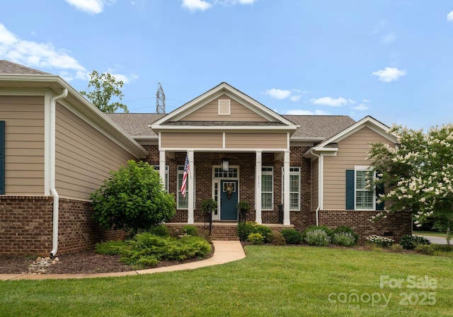 6506 Jepson Ct Unit 349, Charlotte, NC 28214 - view of front of property featuring brick siding, a front lawn, and a shingled roof