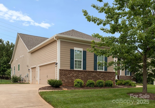 6506 Jepson Ct Unit 349, Charlotte, NC 28214 - view of home's exterior featuring brick siding, concrete driveway, a yard, a shingled roof, and a garage