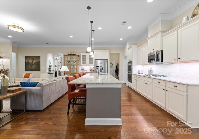 6506 Jepson Ct Unit 349, Charlotte, NC 28214 - kitchen with stainless steel appliances, ornamental molding, a kitchen breakfast bar, dark wood finished floors, and white cabinetry