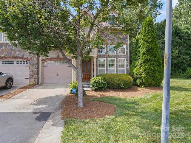 1169 Stuarts Landing Dr, Cramerton, NC 28032 - view of property hidden behind natural elements with stone siding, driveway, a front lawn, and a garage