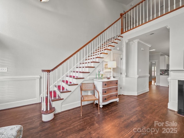 1169 Stuarts Landing Dr, Cramerton, NC 28032 - stairs featuring crown molding, wood finished floors, and a towering ceiling