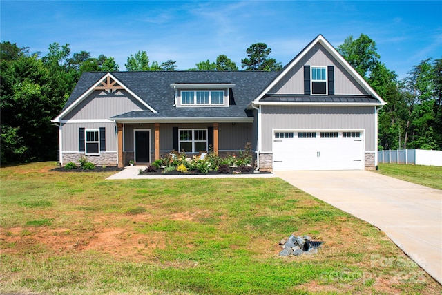 205 Spring Creek Dr, Mount Holly, NC 28120 - craftsman-style home featuring stone siding, driveway, roof with shingles, a standing seam roof, and a garage