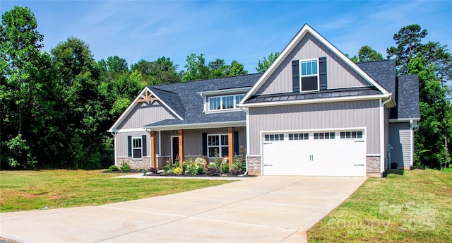 205 Spring Creek Dr, Mount Holly, NC 28120 - craftsman inspired home with a standing seam roof, stone siding, concrete driveway, a front yard, and a shingled roof