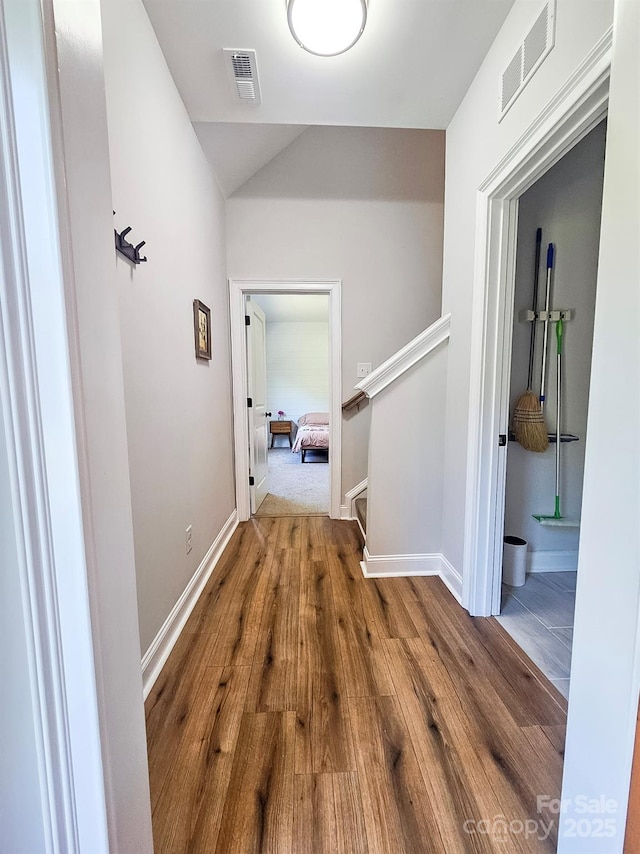 205 Spring Creek Dr, Mount Holly, NC 28120 - hallway with wood finished floors, stairs, and lofted ceiling