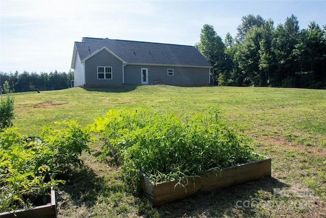 205 Spring Creek Dr, Mount Holly, NC 28120 - rear view of house with a garden and a lawn