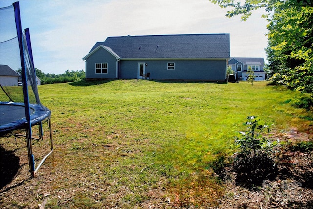 205 Spring Creek Dr, Mount Holly, NC 28120 - back of property with a trampoline and a yard