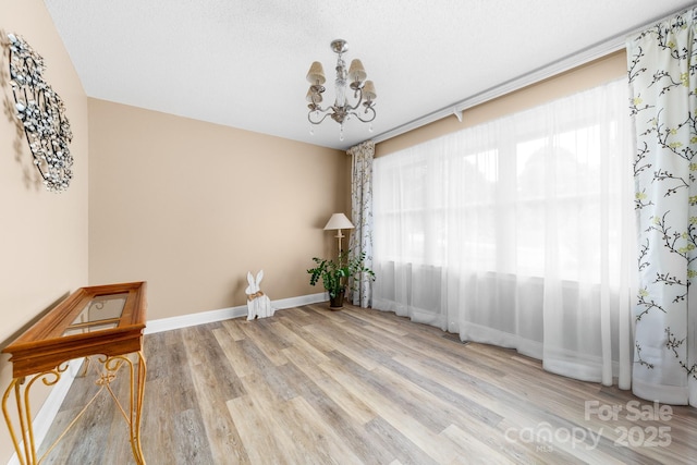 7029 Forest Hills Dr, Denver, NC 28037 - empty room with a chandelier and wood finished floors