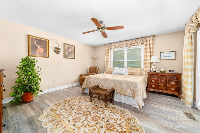 7029 Forest Hills Dr, Denver, NC 28037 - bedroom with wood finished floors, a ceiling fan, and a textured ceiling
