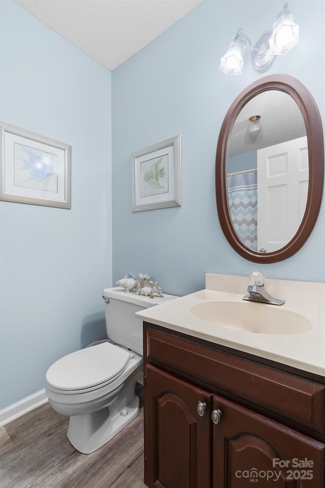 7029 Forest Hills Dr, Denver, NC 28037 - full bath featuring wood finished floors, vanity, and a textured ceiling