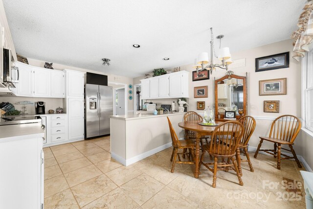 7029 Forest Hills Dr, Denver, NC 28037 - dining room featuring a chandelier and light tile patterned flooring