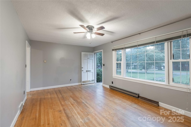 1132 Arbor Dr, Salisbury, NC 28144 - spare room featuring baseboard heating, light wood-type flooring, ceiling fan, and a textured ceiling