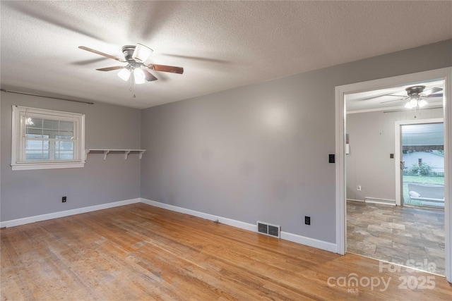1132 Arbor Dr, Salisbury, NC 28144 - spare room with a ceiling fan, healthy amount of natural light, light wood-style floors, and a textured ceiling