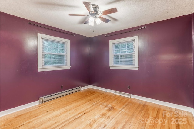 1132 Arbor Dr, Salisbury, NC 28144 - empty room featuring a baseboard radiator, wood finished floors, healthy amount of natural light, ceiling fan, and a textured ceiling