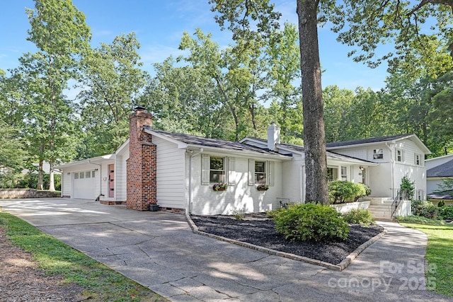 5611 Robinhood Rd, Charlotte, NC 28211 - view of front of house with a chimney, a garage, and concrete driveway