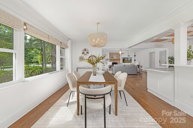 5611 Robinhood Rd, Charlotte, NC 28211 - dining area featuring a chandelier, light wood-type flooring, and ornamental molding