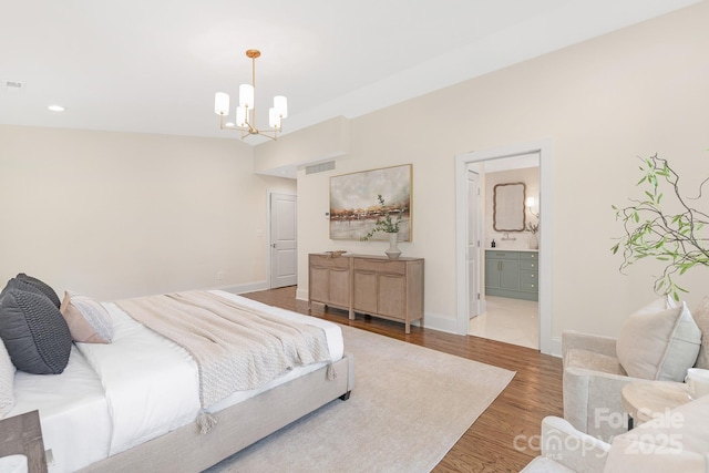 5611 Robinhood Rd, Charlotte, NC 28211 - bedroom featuring wood finished floors, a chandelier, recessed lighting, and ensuite bathroom