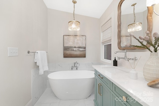 5611 Robinhood Rd, Charlotte, NC 28211 - full bathroom featuring a chandelier, marble look tile flooring, a freestanding tub, and vanity