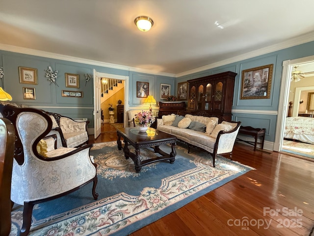 192 W Court St, Rutherfordton, NC 28139 - living room with stairs, a decorative wall, crown molding, and wood finished floors