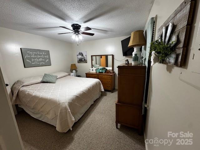 3375 Shepherd Rd, Maiden, NC 28650 - bedroom with light carpet, a textured ceiling, and a ceiling fan