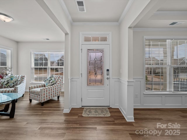 9582 Creighton Rd NW, Concord, NC 28027 - foyer entrance featuring wood finished floors, a wainscoted wall, a decorative wall, and crown molding