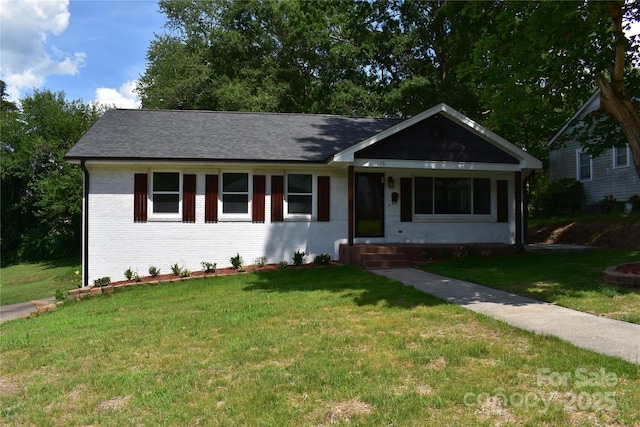1038 Holmes Ave, Salisbury, NC 28144 - ranch-style home with brick siding, a front yard, and a shingled roof