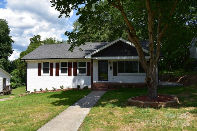 1038 Holmes Ave, Salisbury, NC 28144 - view of front of house with brick siding, a front lawn, and roof with shingles