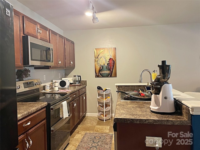 9608 Brackenview Ct, Charlotte, NC 28214 - kitchen featuring appliances with stainless steel finishes, dark countertops, and track lighting