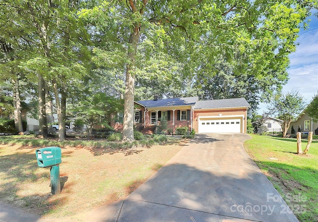 16509 Kimbolten Dr, Huntersville, NC 28078 - view of front of house featuring a garage, concrete driveway, and brick siding