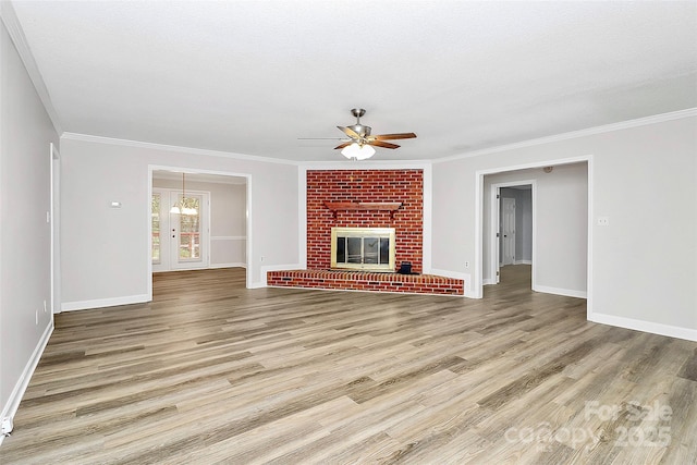 16509 Kimbolten Dr, Huntersville, NC 28078 - unfurnished living room featuring a ceiling fan, light wood-style flooring, crown molding, and a brick fireplace