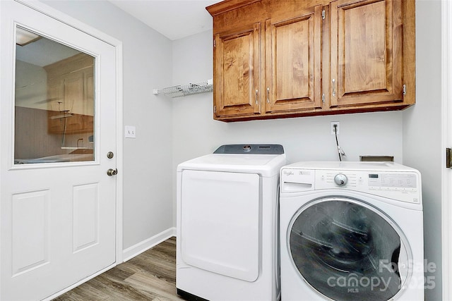 16509 Kimbolten Dr, Huntersville, NC 28078 - laundry room featuring cabinet space, separate washer and dryer, and wood finished floors