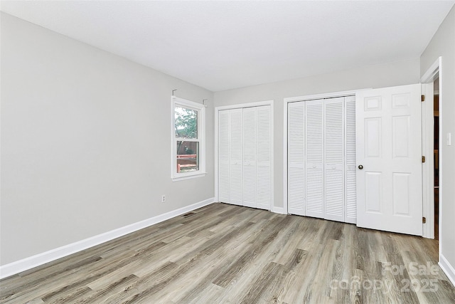 16509 Kimbolten Dr, Huntersville, NC 28078 - unfurnished bedroom with wood finished floors and two closets