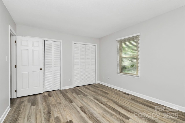 16509 Kimbolten Dr, Huntersville, NC 28078 - unfurnished bedroom with two closets and wood finished floors