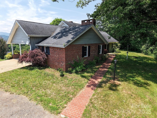 80 Gobblers Knob Dr, Clyde, NC 28721 - view of side of home with brick siding, a shingled roof, and a yard
