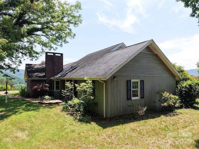 80 Gobblers Knob Dr, Clyde, NC 28721 - view of side of home featuring a yard, a chimney, and a shingled roof